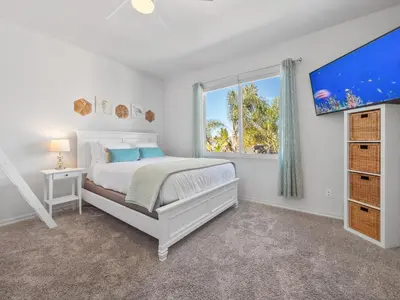 a bedroom with a bed and a large window at Pacific Beach Dreaming - AC, walk 2 town, garage & beach in San Diego