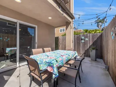 a table and chairs on a patio with a table and a table and chairs at Pacific Beach Dreaming - AC, walk 2 town, garage & beach in San Diego