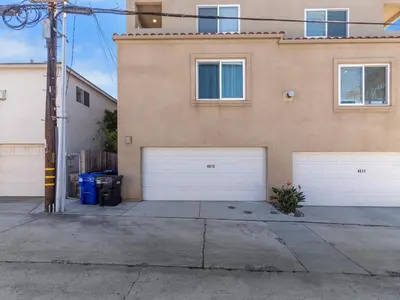 a house with two garage doors in front of it at Pacific Beach Dreaming - AC, walk 2 town, garage & beach in San Diego