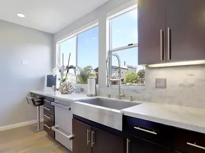 a kitchen with a sink and a large window at Haines Luxury Dream Home - Bay Views, Rooftop, Fire Pit & AC in San Diego