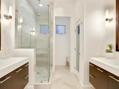 a bathroom with two sinks and a glass shower at Haines Luxury Dream Home - Bay Views, Rooftop, Fire Pit & AC in San Diego