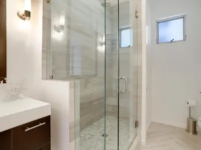 a glass shower in a bathroom with a sink at Haines Luxury Dream Home - Bay Views, Rooftop, Fire Pit & AC in San Diego