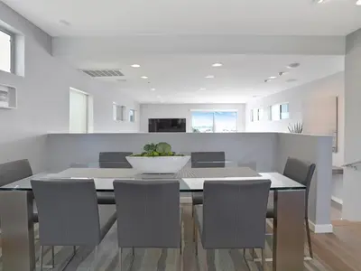 a dining room with a table and chairs at Haines Luxury Dream Home - Bay Views, Rooftop, Fire Pit & AC in San Diego