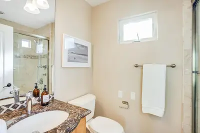a bathroom with a sink and a toilet at Massive Dream Beach Home - Dog Friendly, AC, Steps2Sand in San Diego