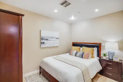a bedroom with a bed and a dresser at Massive Dream Beach Home - Dog Friendly, AC, Steps2Sand in San Diego