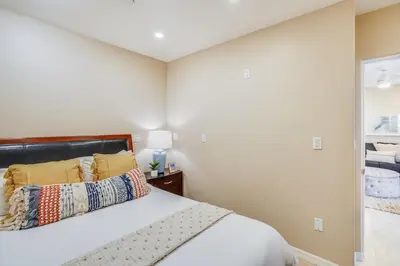 a bedroom with a bed and a mirror at Massive Dream Beach Home - Dog Friendly, AC, Steps2Sand in San Diego