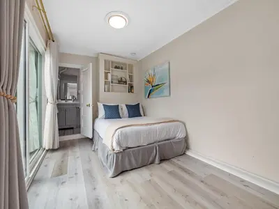 a bedroom with a bed and a large window at Stunning Oceanfront Villa - Massive Patio, Hot Tub, Parking, Pet Friendly & Views! in San Diego
