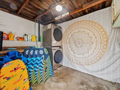 a garage with a surfboard and a wall with a mandala at Sunset Cliffs Oceanfront Casita w Fast Wifi, Large Outdoor Space & Ocean Breeze! in San Diego