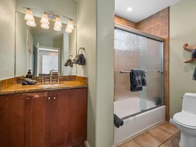 a bathroom with a shower and a sink and a toilet at Stunning Beach House- Rooftop Patio & Ocean Views in San Diego
