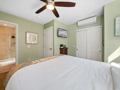 a bedroom with a bed and a ceiling fan at Stunning Beach House- Rooftop Patio & Ocean Views in San Diego