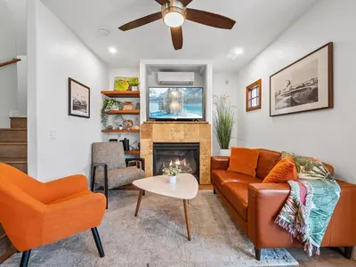 a living room with a couch and a fireplace at Stunning Beach House- Rooftop Patio & Ocean Views in San Diego