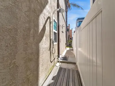 a shadow of a street light on the side of a building at Stunning Beach House- Rooftop Patio & Ocean Views in San Diego