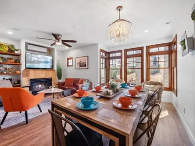 a dining room with a table with chairs and a fireplace at Stunning Beach House- Rooftop Patio & Ocean Views in San Diego
