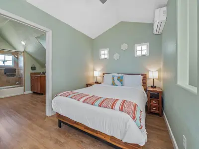 a bedroom with a large bed in a room at Stunning Beach House- Rooftop Patio & Ocean Views in San Diego