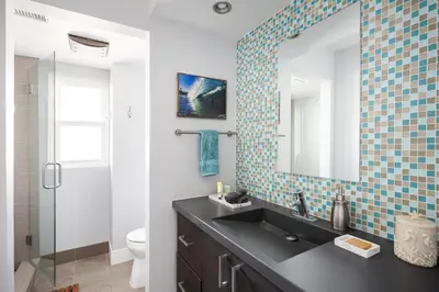 a bathroom with a black sink and a mirror at Oceanfront, two-level condo with stunning view, decks, fast WiFi & fireplace in San Diego