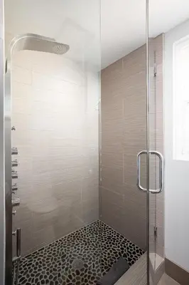 a bathroom with a shower with a glass door at Oceanfront, two-level condo with stunning view, decks, fast WiFi & fireplace in San Diego