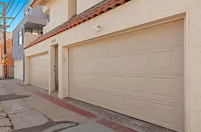 two garage doors on the side of a building at Oceanfront, two-level condo with stunning view, decks, fast WiFi & fireplace in San Diego