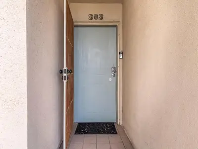 a blue door with the number eighty eighty on it at Sunset Cliffs Lookout - Ocean Front Luxury Condo in San Diego
