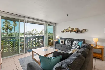 a living room with a couch and a large window at Belmont Modern - Ocean View, Pet Friendly, Patio in San Diego
