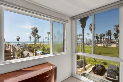 a room with windows with a view of the beach at Belmont Modern - Ocean View, Pet Friendly, Patio in San Diego