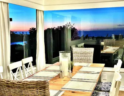 a table on a balcony with a view of the city at Endless Vistas On The Cove Perfection - Spa, Pet-Friendly, Stunning Views, Large Parking & AC in San Diego
