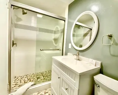 a bathroom with a sink and a shower and a mirror at Endless Vistas On The Cove Perfection - Spa, Pet-Friendly, Stunning Views, Large Parking & AC in San Diego