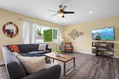 a living room with a couch and a table at Dog Friendly Home Near the Beach with Grill, Fire Pit, Enclosed Backyard in San Diego