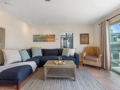 a living room with a blue couch and a table at Ocean View Beach Haven! Steps2Beach & Pet Friendly in San Diego