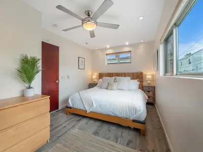 a bedroom with a bed and a ceiling fan at Ocean View Beach Haven! Steps2Beach & Pet Friendly in San Diego