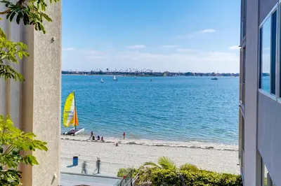 a view of a beach and the ocean from a building at Bayfront Paradise - Flexible 30 Day plus w Amazing Bay View and Pool in San Diego