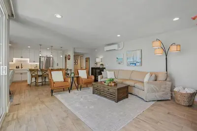 a living room with a couch and a table at Bayfront Paradise - Flexible 30 Day plus w Amazing Bay View and Pool in San Diego