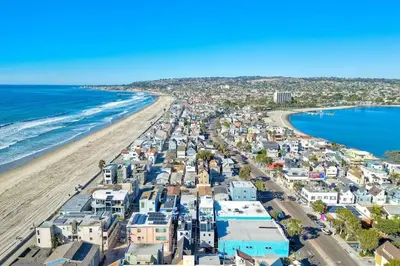 an aerial view of a beach with houses and the ocean at NEW Luxury Beach Home I 3BR I Balcony I Firepit in San Diego