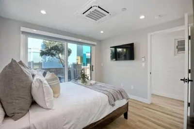 a bedroom with a bed and a large window at NEW Luxury Beach Home I 3BR I Balcony I Firepit in San Diego