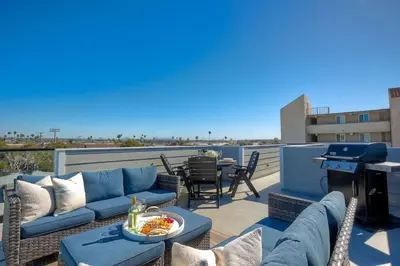 a patio with a couch and a table with a grill at NEW Luxury Beach Home I 3BR I Balcony I Firepit in San Diego
