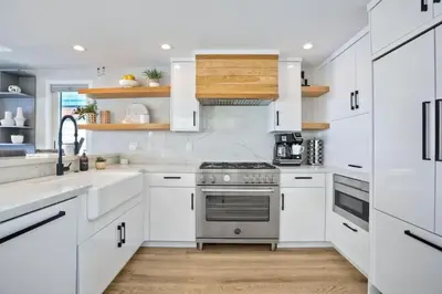 a kitchen with white cabinets and a stove at Luxury Ocean Oasis 3BR I Balcony I Firepit in San Diego