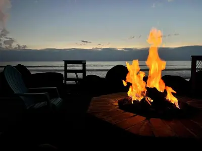 a fire pit on the beach with the ocean in the background at Oceanfront Home with Stunning View in Oceanside
