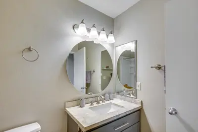 a bathroom with a sink and a mirror at Downtown San Diego Condo 1 Mi to Gaslamp Quarter in San Diego