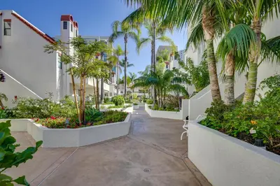a courtyard with palm trees in a building at Downtown San Diego Condo 1 Mi to Gaslamp Quarter in San Diego