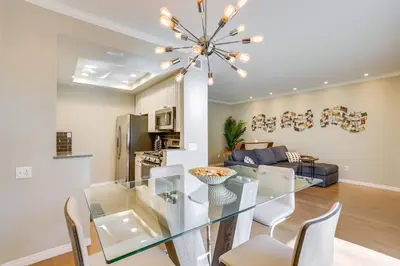 a dining room and living room with a glass table and chairs at Downtown San Diego Condo 1 Mi to Gaslamp Quarter in San Diego