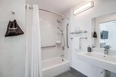 a white bathroom with a shower and a sink at Park Blvd 301 - Modern - Urban Oasis - SPA in San Diego