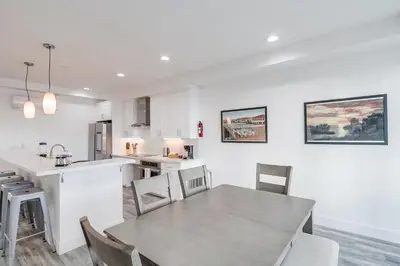 a kitchen and dining room with a table and chairs at Park Blvd 302 - Newly Built - Spa - Central in San Diego