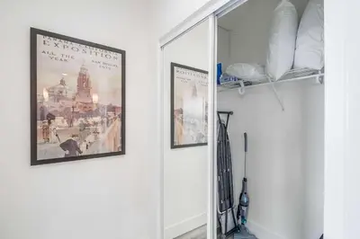 a hallway with two pictures on the wall and a mirror at Park Blvd 302 - Newly Built - Spa - Central in San Diego