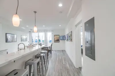 a white room with a long bar with stools at Park Blvd 302 - Newly Built - Spa - Central in San Diego