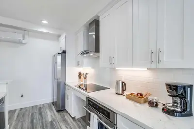 a kitchen with white cabinets and a counter top at Park Blvd 302 - Newly Built - Spa - Central in San Diego