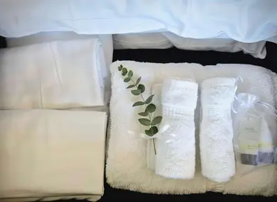 a bed with two white towels with a plant on them at Park Blvd Paradise 303 king bed With a private Spa in San Diego