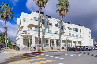 a white building with palm trees in front of it at Park Blvd Paradise 303 king bed With a private Spa in San Diego