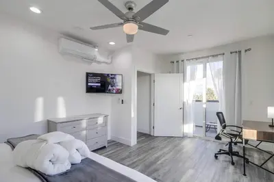 a white bedroom with a bed with a ceiling fan at Park Blvd Paradise 304 New construction, king bed! in San Diego
