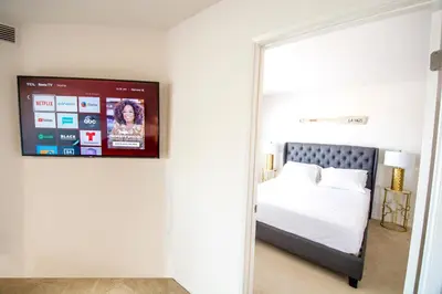 a bedroom with a bed and a tv on the wall at Bay Views & Gaslamp/Little Italy/Convention 1BD in San Diego