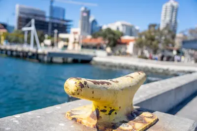 a statue on a ledge next to a body of water at Bay Views & Gaslamp/Little Italy/Convention 1BD in San Diego