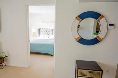 a room with a mirror on the wall and a bed at Bay Views & Gaslamp/Little Italy/Convention 1BD in San Diego